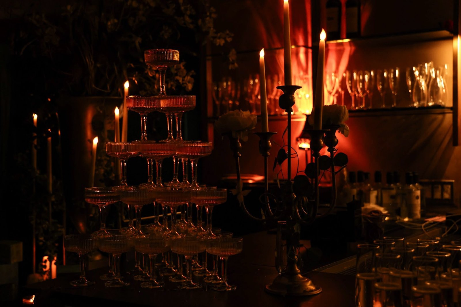 A candlelit champagne coupe tower at the Dejavu bar