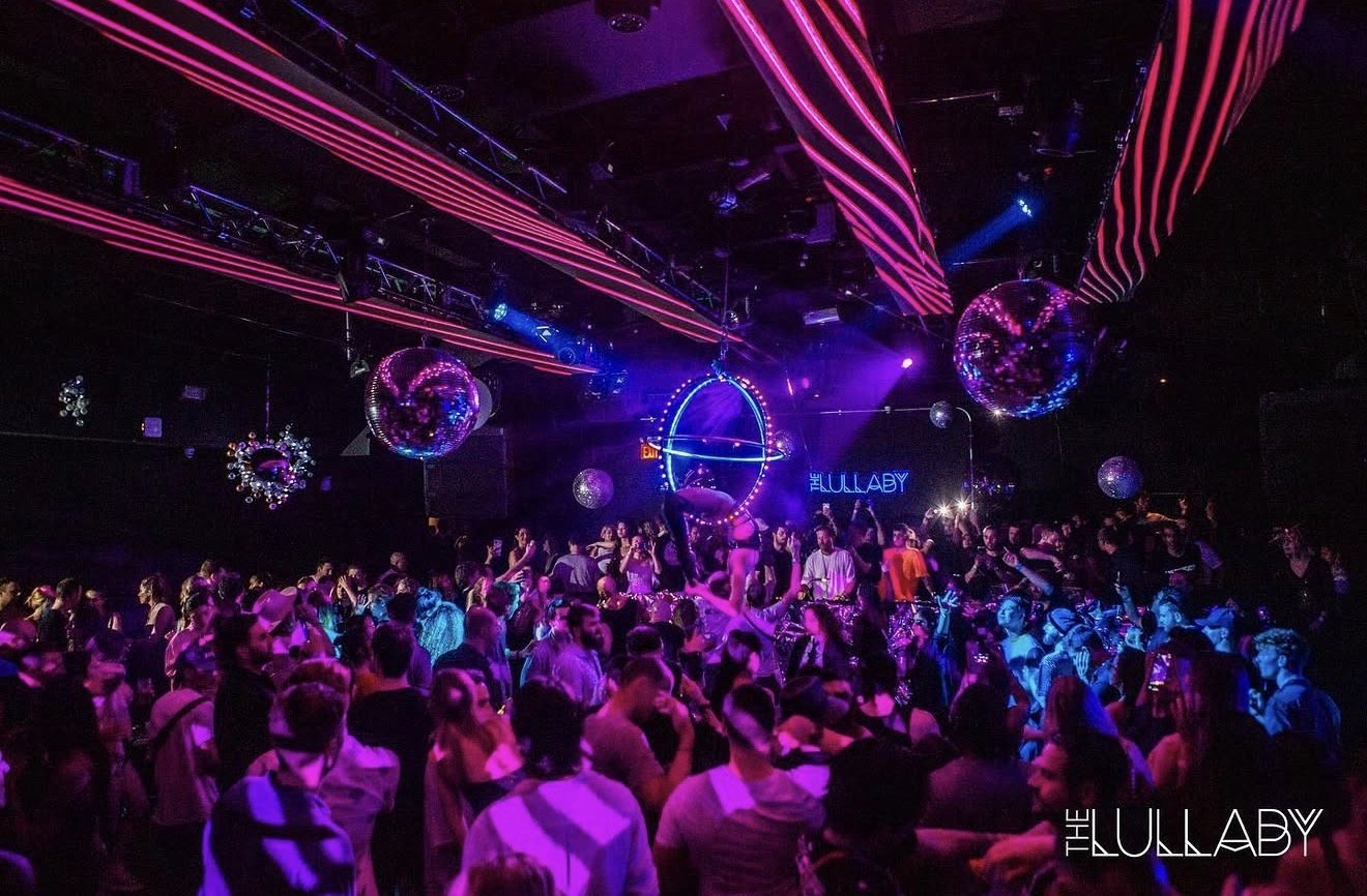 The Lullaby dance floor under pink neon